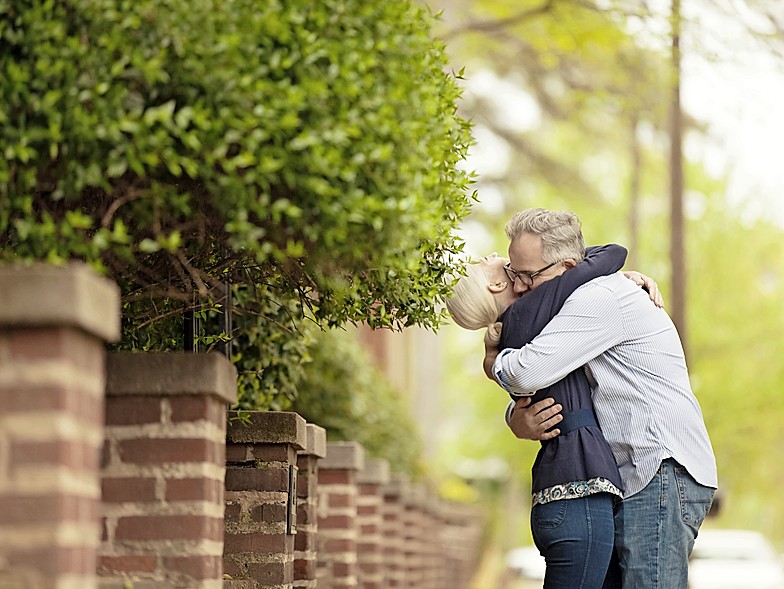 Older couple hugging outside