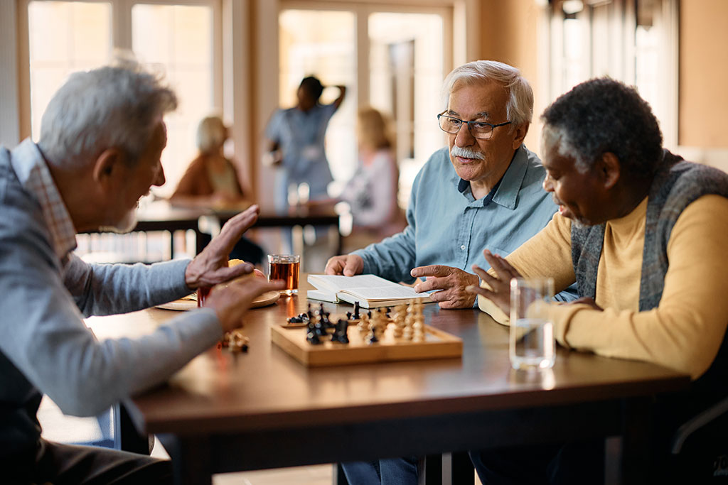 Older men playing games at table
