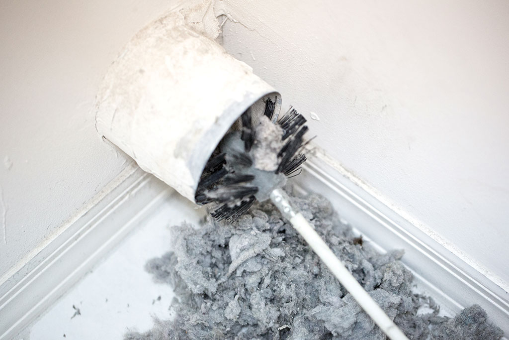 Dryer vent being cleaned