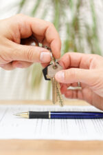 Person giving keys to homeowner