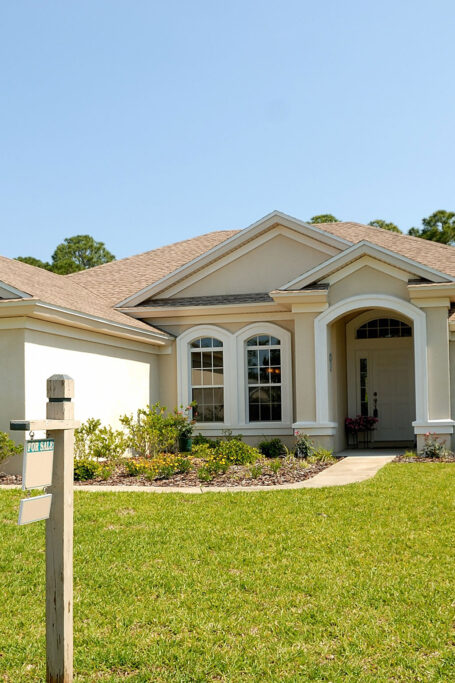 Street view of house with house for sale sign