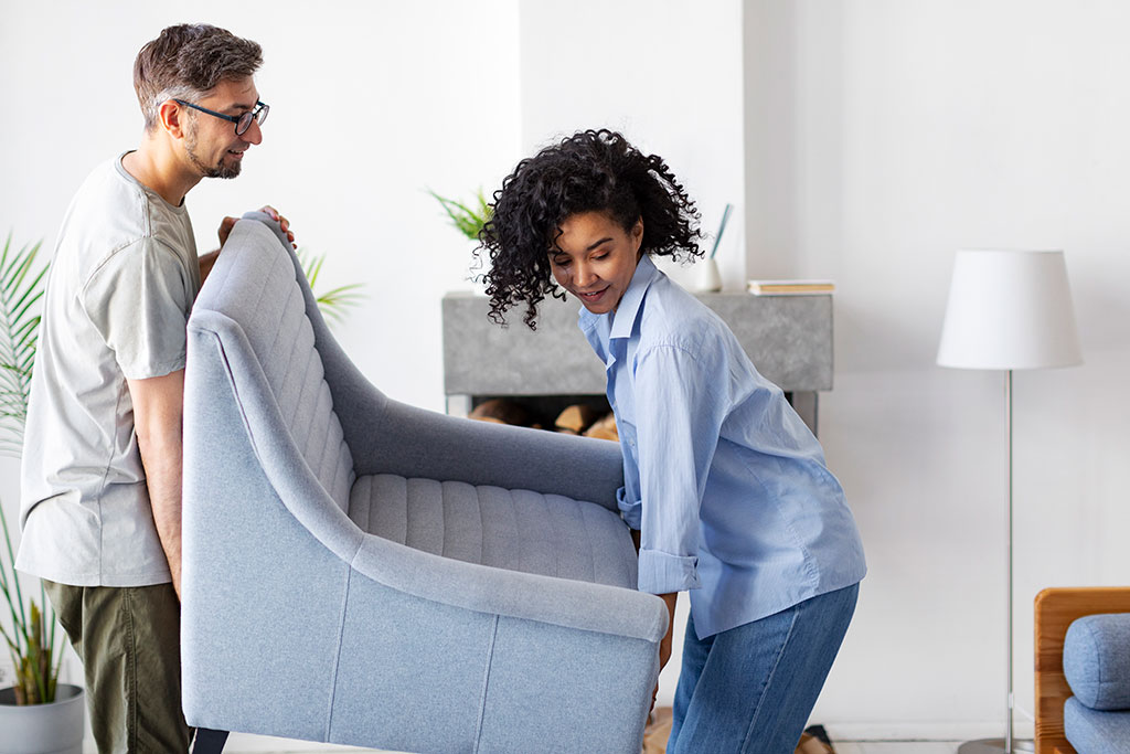 Man and woman moving chair