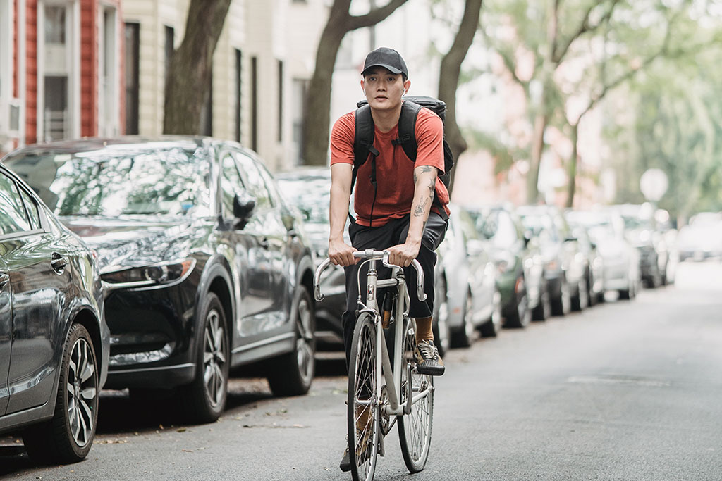 Person riding bike through neighborhood