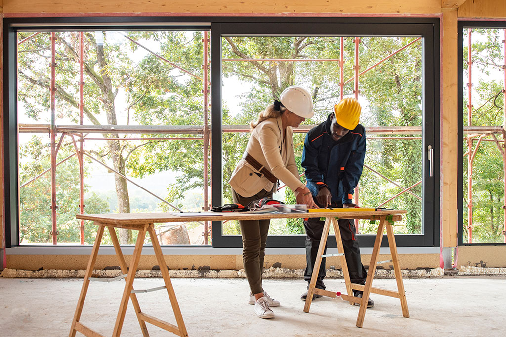 People going over building plans for house