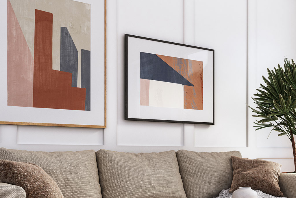 Colorful art hanging on wall over couch