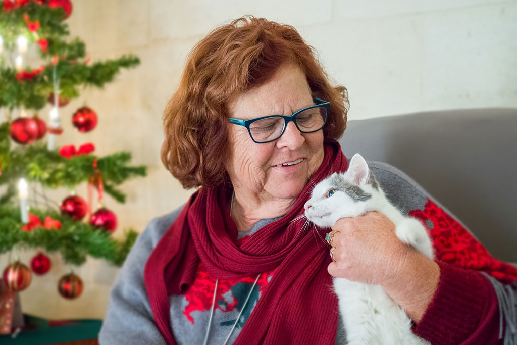 Older woman holding cat