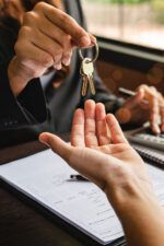 Realtor handing home owner keys