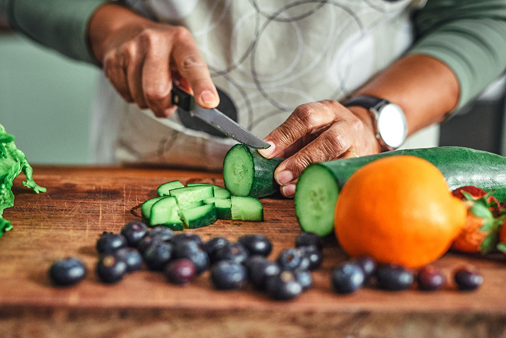 Woman cutting up vegetables