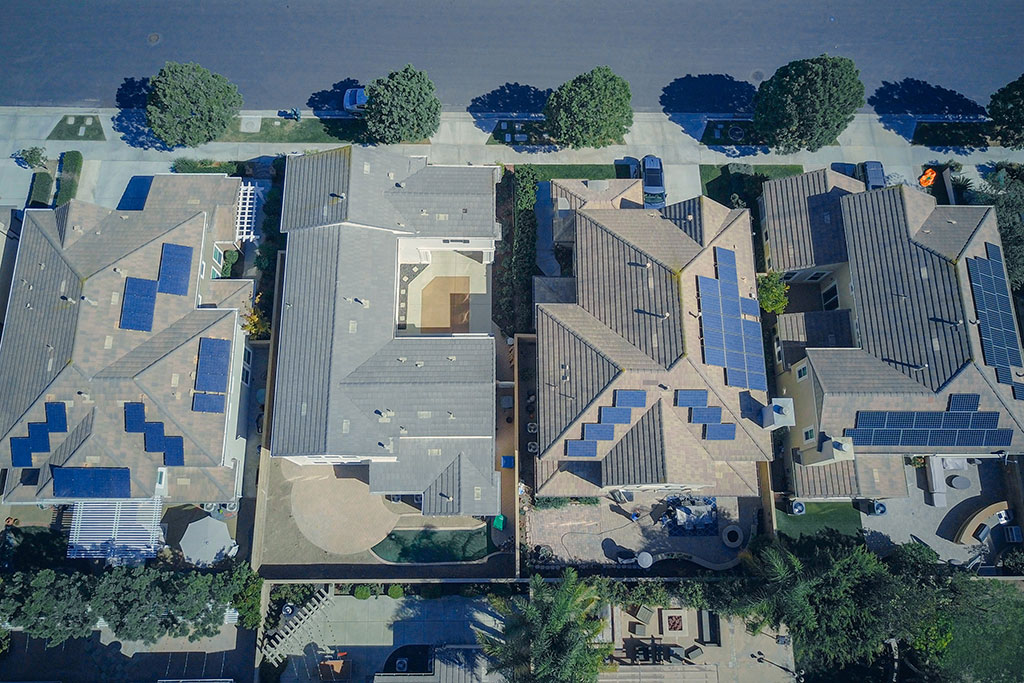 Ariel view of solar panels on houses in neighborhood
