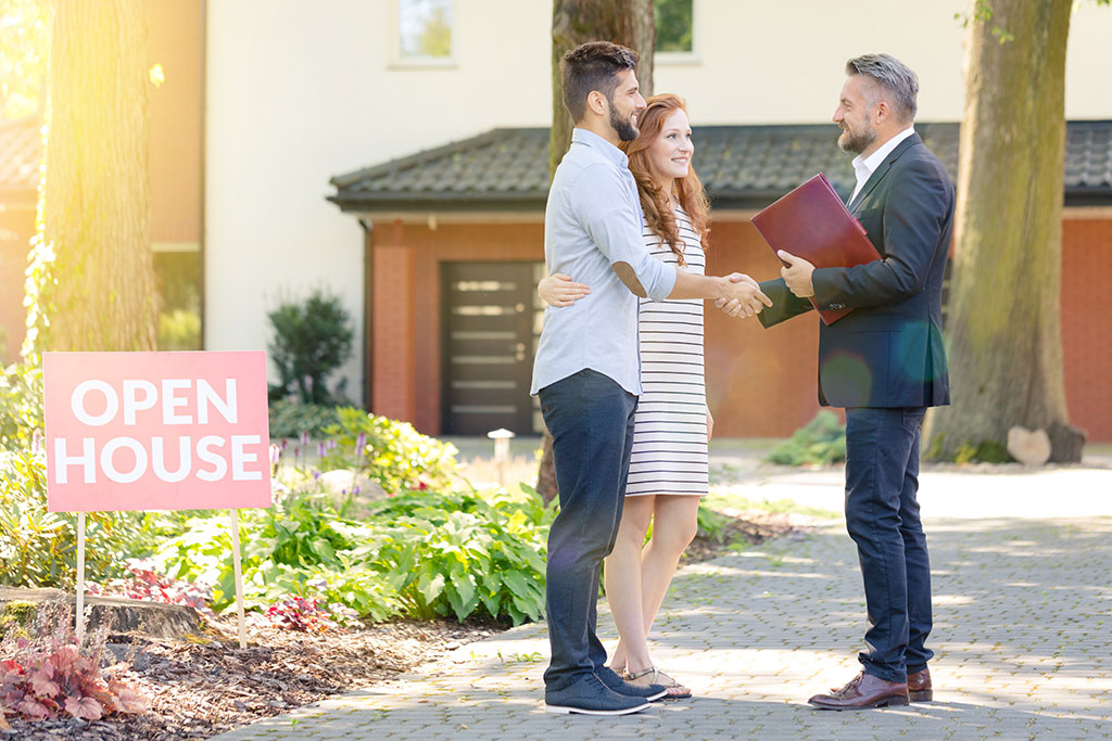 Couple with realtor at open house