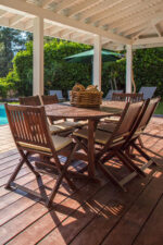 Outside deck by pool with patio furniture
