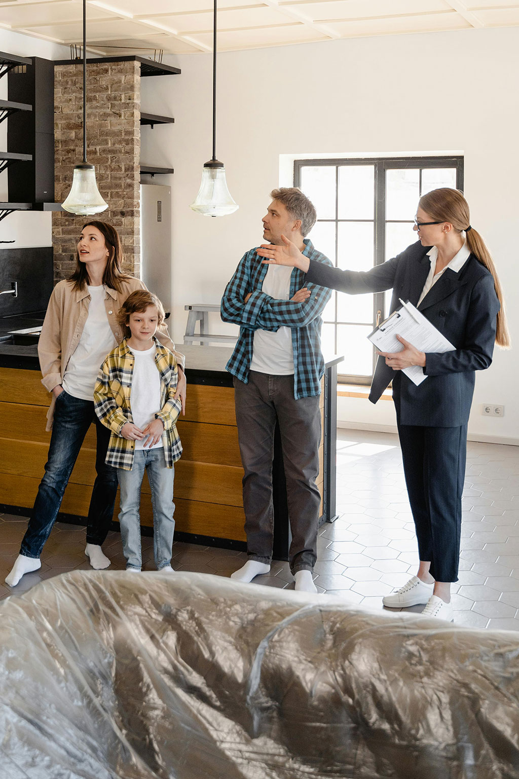 Family looking at house with realtor