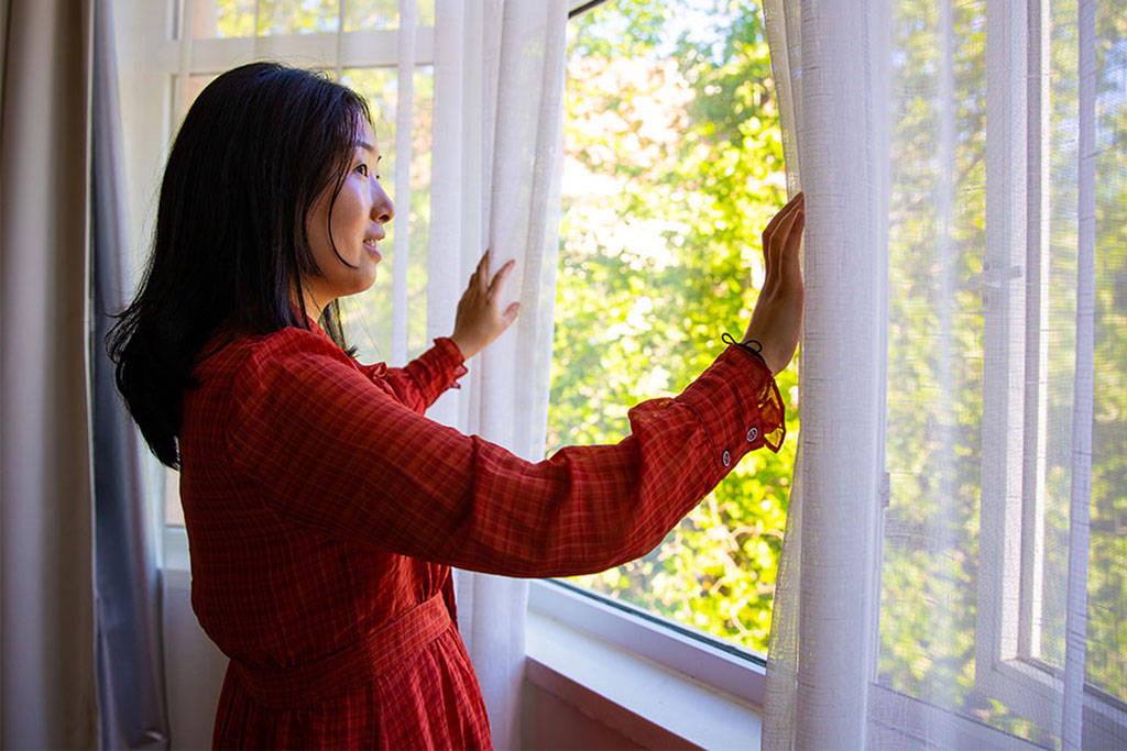 Woman looking out window