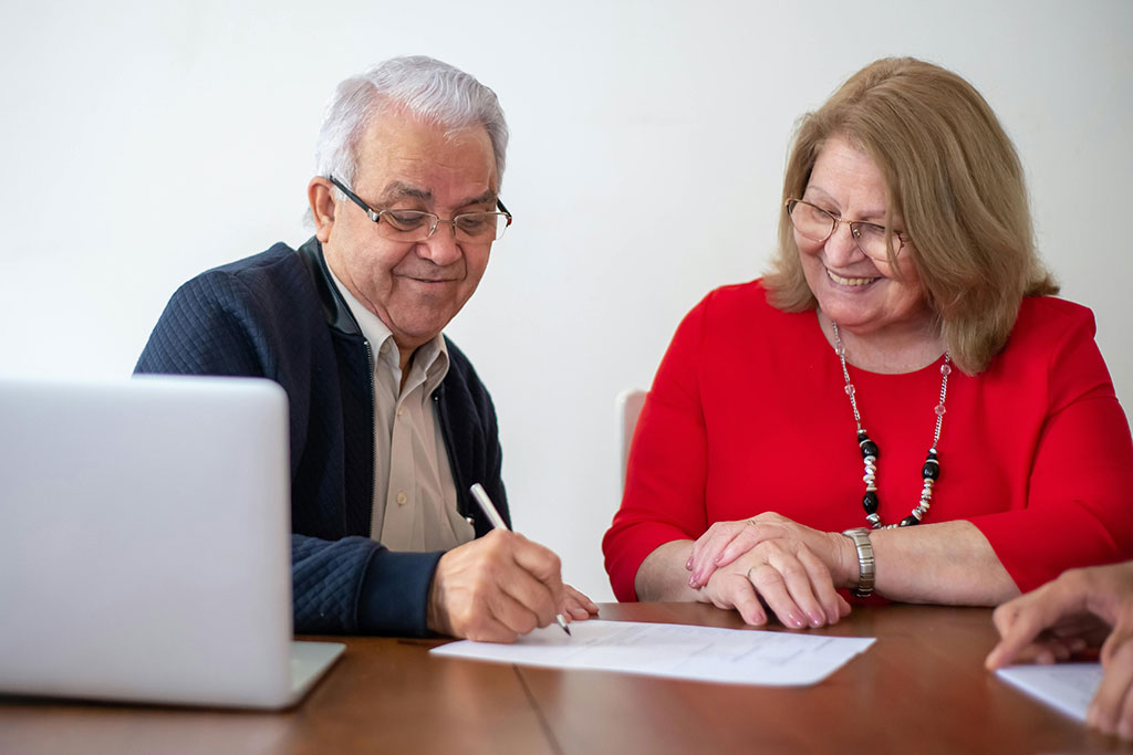 Older couple signing papers