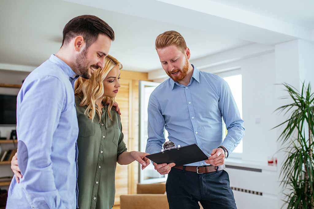 Couple talking with real estate agent