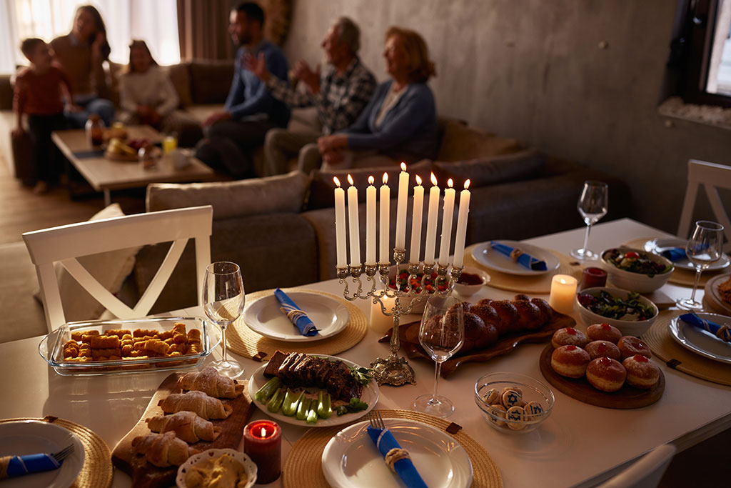 Table set for Hanukkah people in living room talking