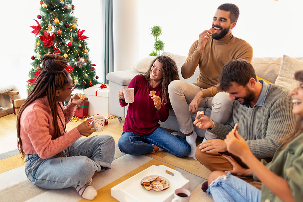 Friends happy eating cooking and talking in living room