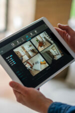 Person looking at surveillance cameras around home