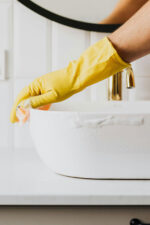 Person cleaning sink