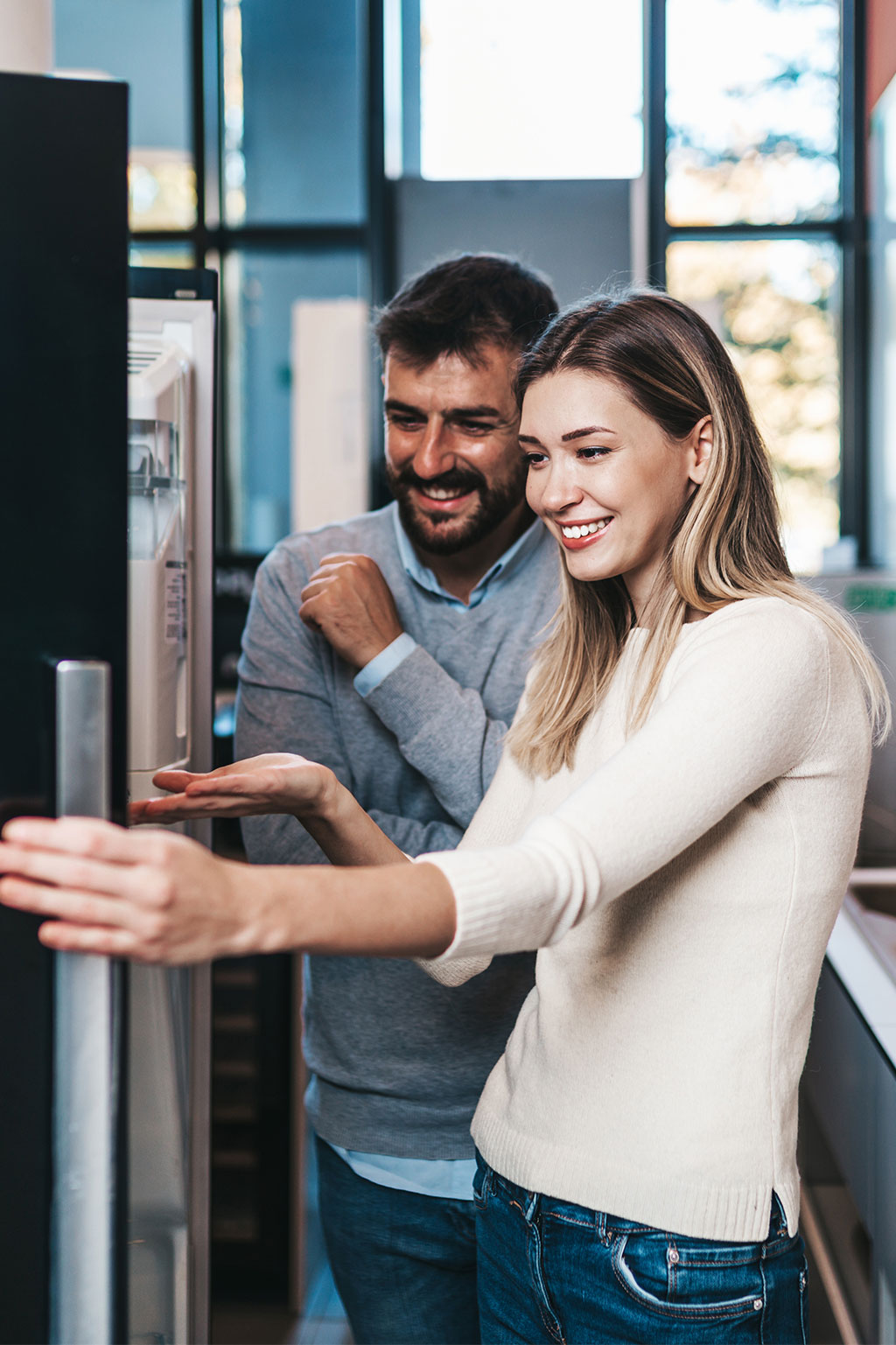 Couple opening fridge