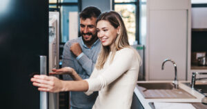 Couple opening fridge