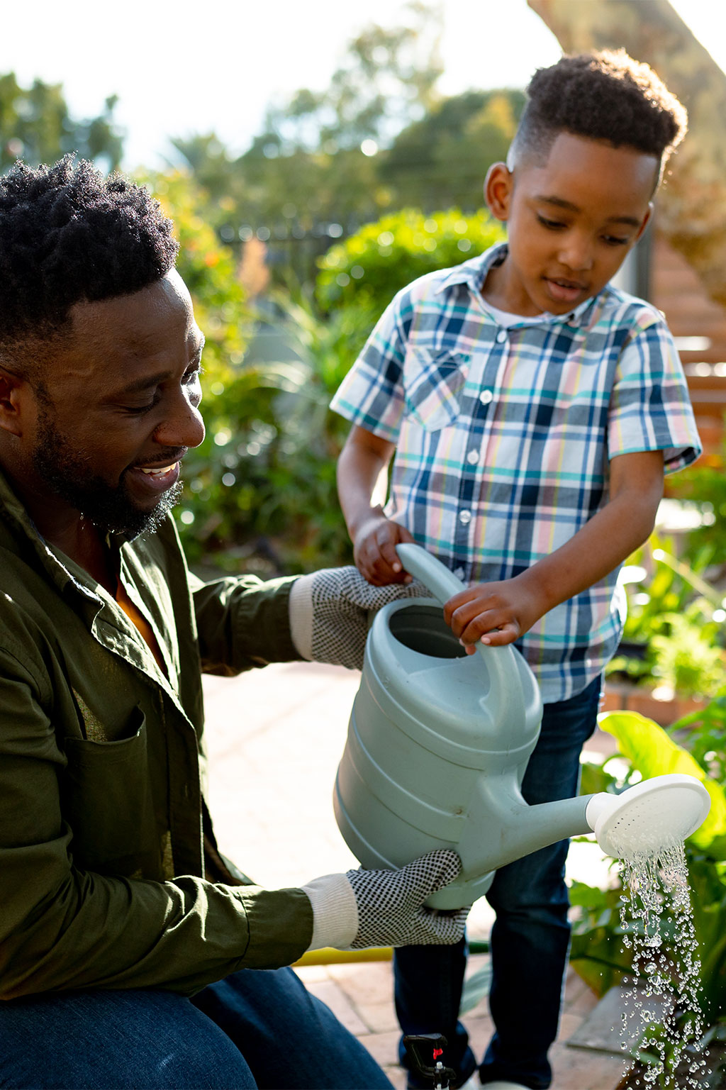 Dad and son watering plants