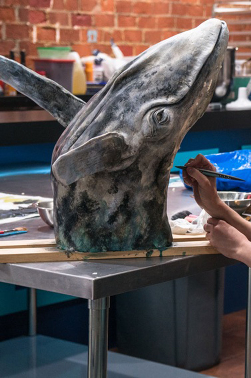 Woman creating realistic whale cake