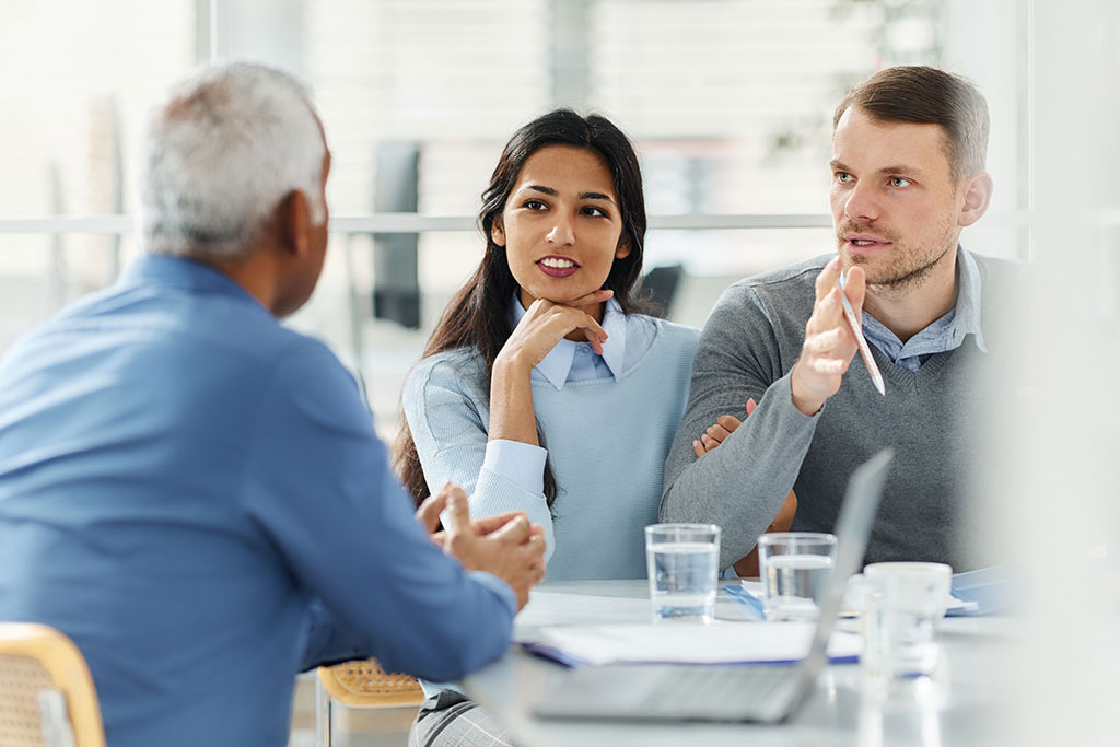 Couple talking to real estate advisor