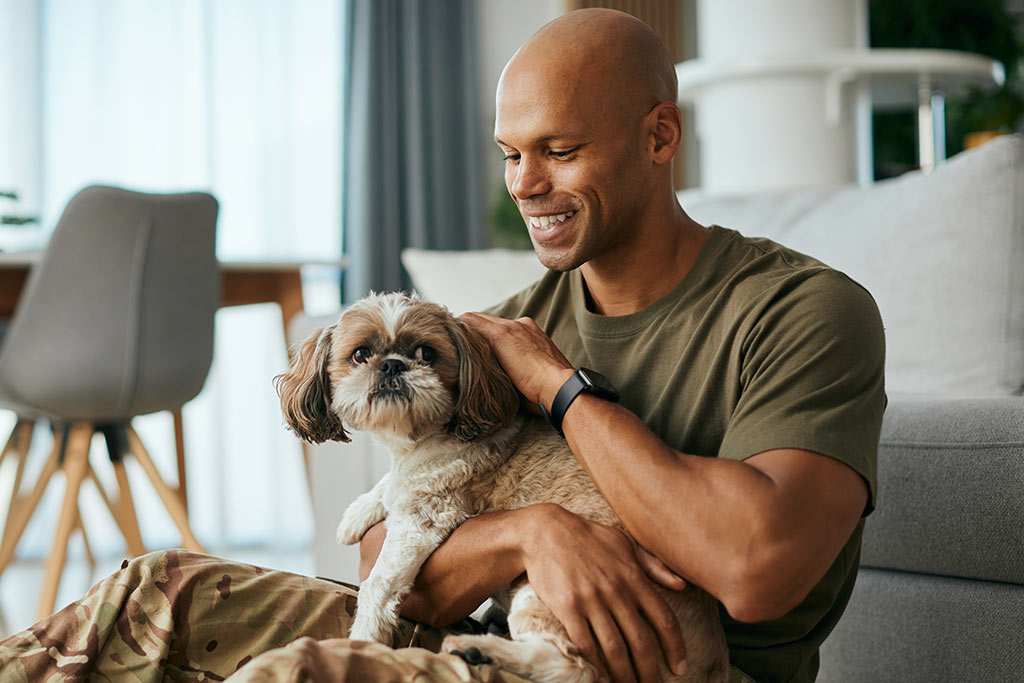 Man petting dog in lap