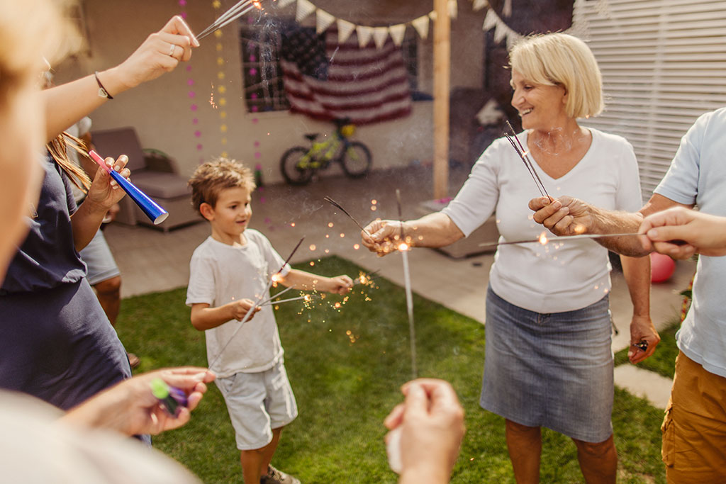Family doing sparklers for Fourth of July