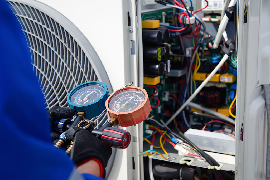 Maintenance person looking at HVAC