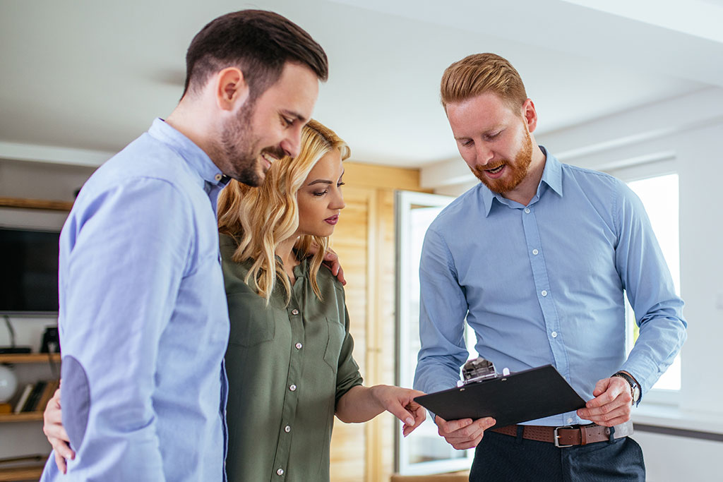 Couple speaking with realtor