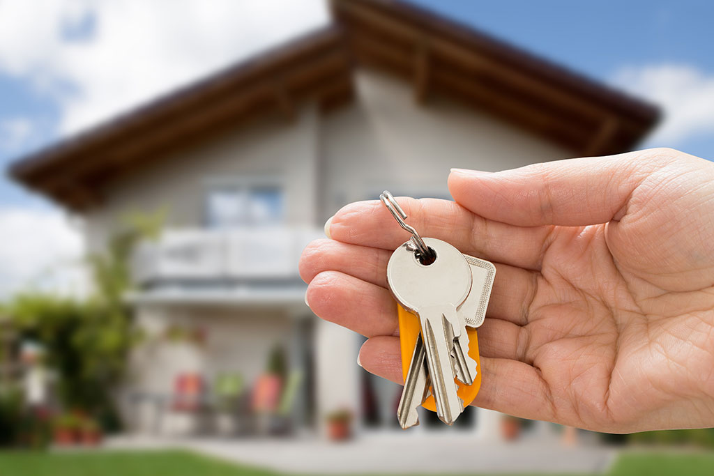 Person holding keys to new house