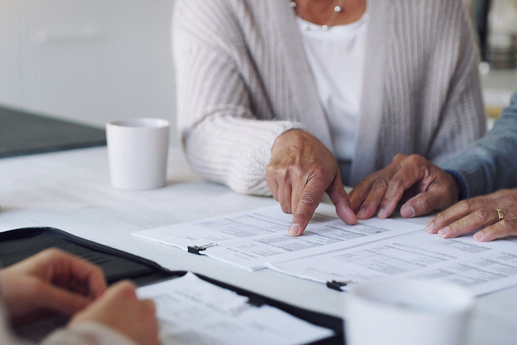 People with advisor looking over paperwork