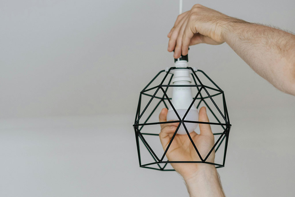 Person replacing light bulb