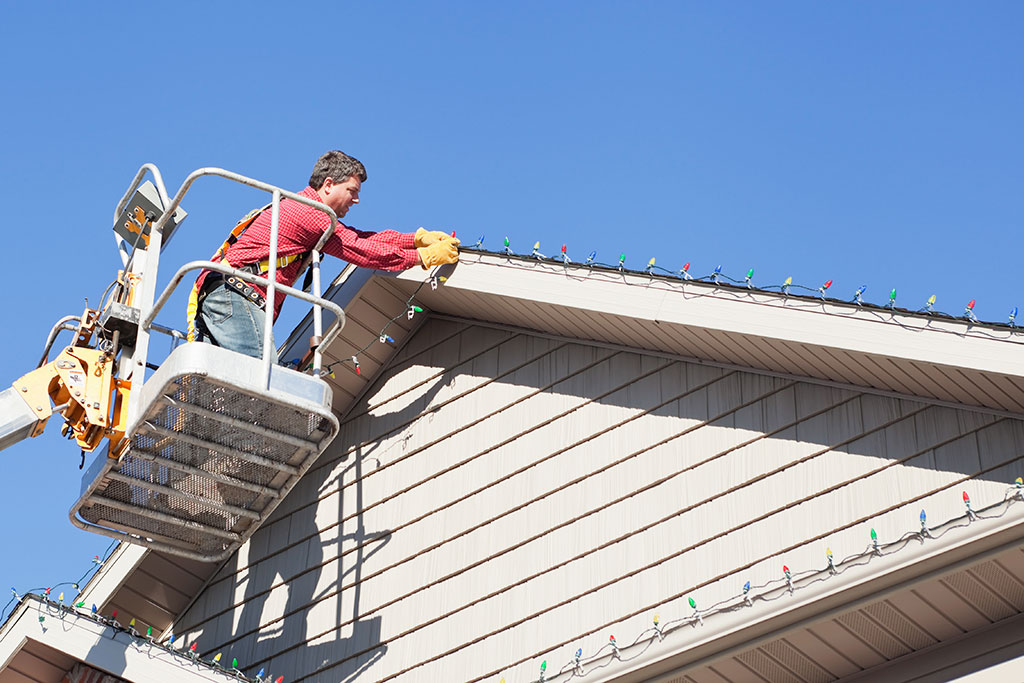 Man putting up Christmas lights
