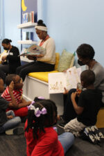 Kids reading books with teachers