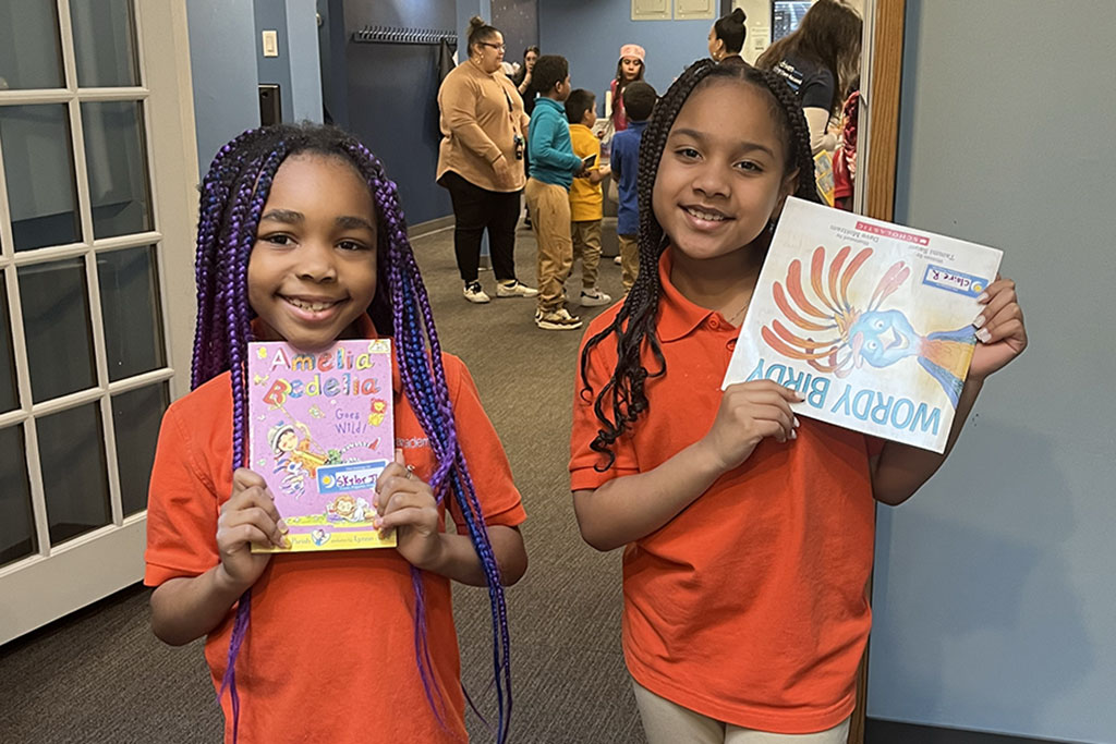 Kids holding up books