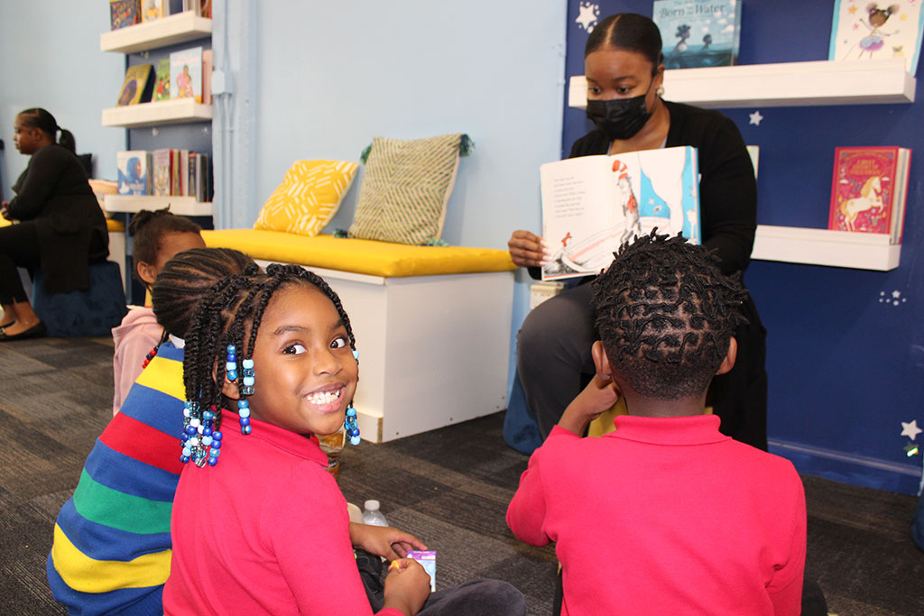 Kids reading books with teachers